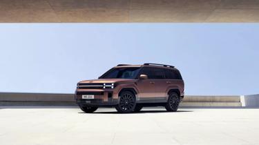 a brown suv is parked under a bridge