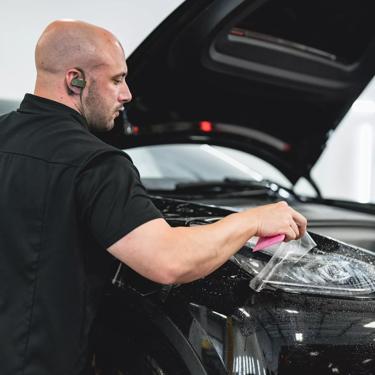 A black 2022 Tesla Model Y is transformed and protected with full coverage STEALTH PPF, providing a sleek, satin finish.
