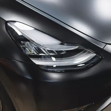 A black 2022 Tesla Model Y is transformed and protected with full coverage STEALTH PPF, providing a sleek, satin finish.