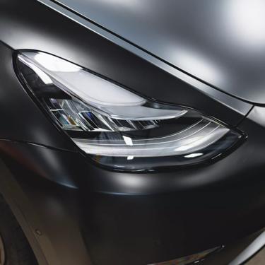 A black 2022 Tesla Model Y is transformed and protected with full coverage STEALTH PPF, providing a sleek, satin finish.